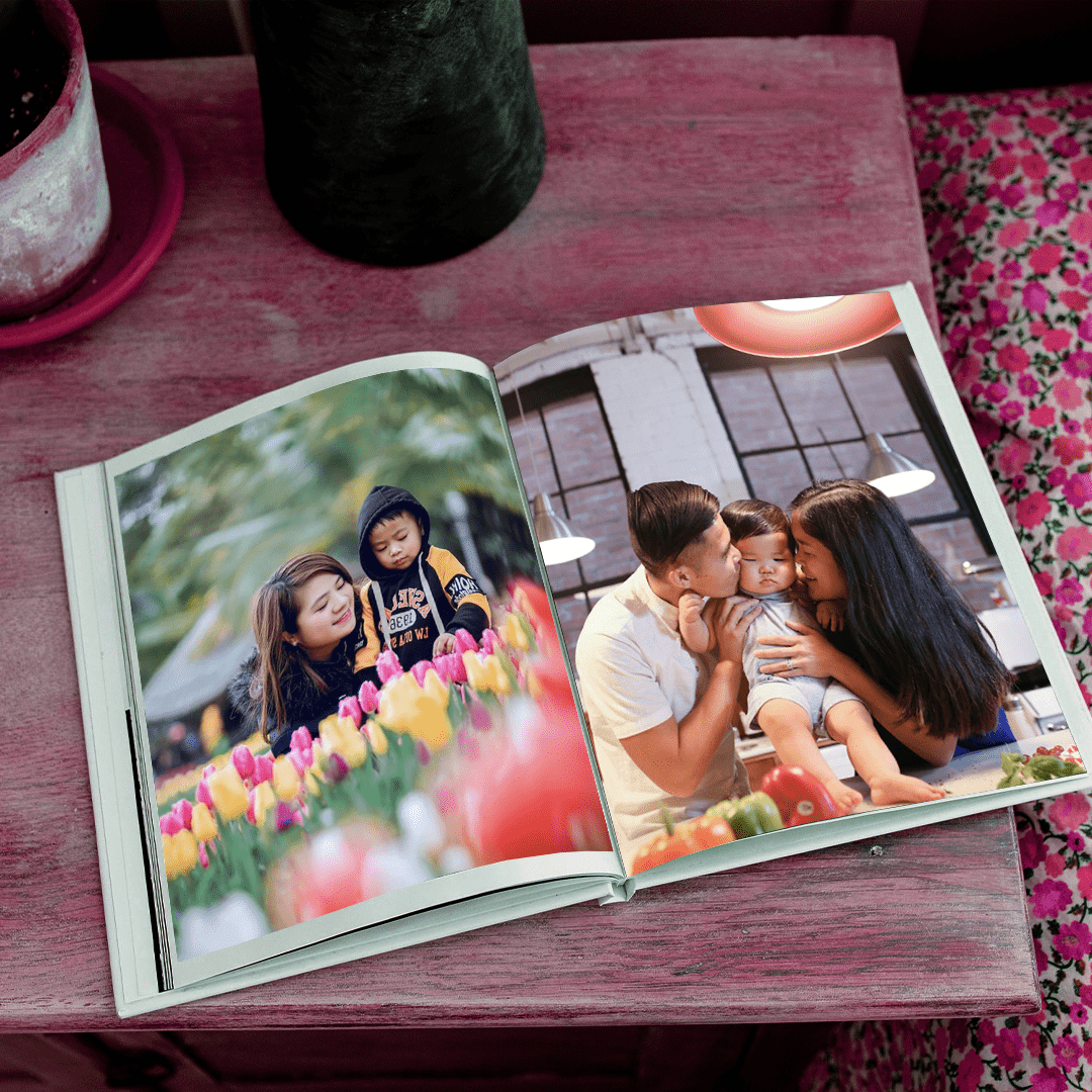 Photo book and pink vase on table. Perfect Christmas gift ideas from Singapore