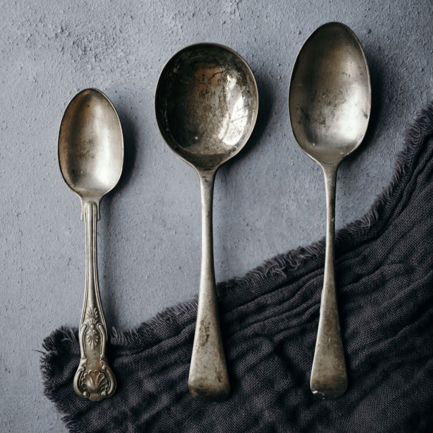 Picture of 3 antique spoons placed on the floor