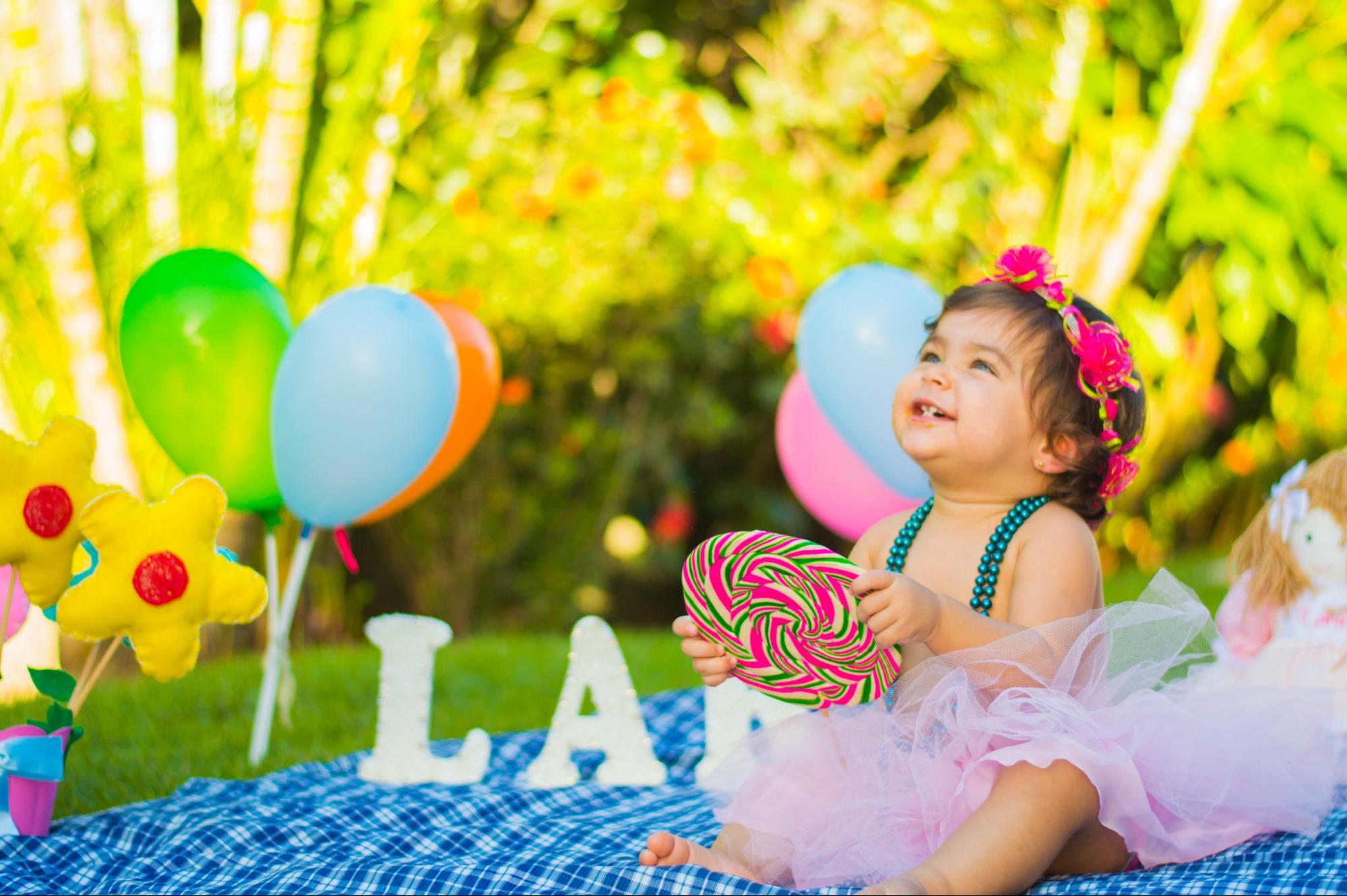 Smiling baby with balloons