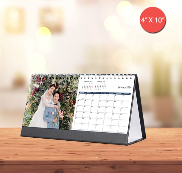 Personalized wedding calendar on a desk with bokeh lights