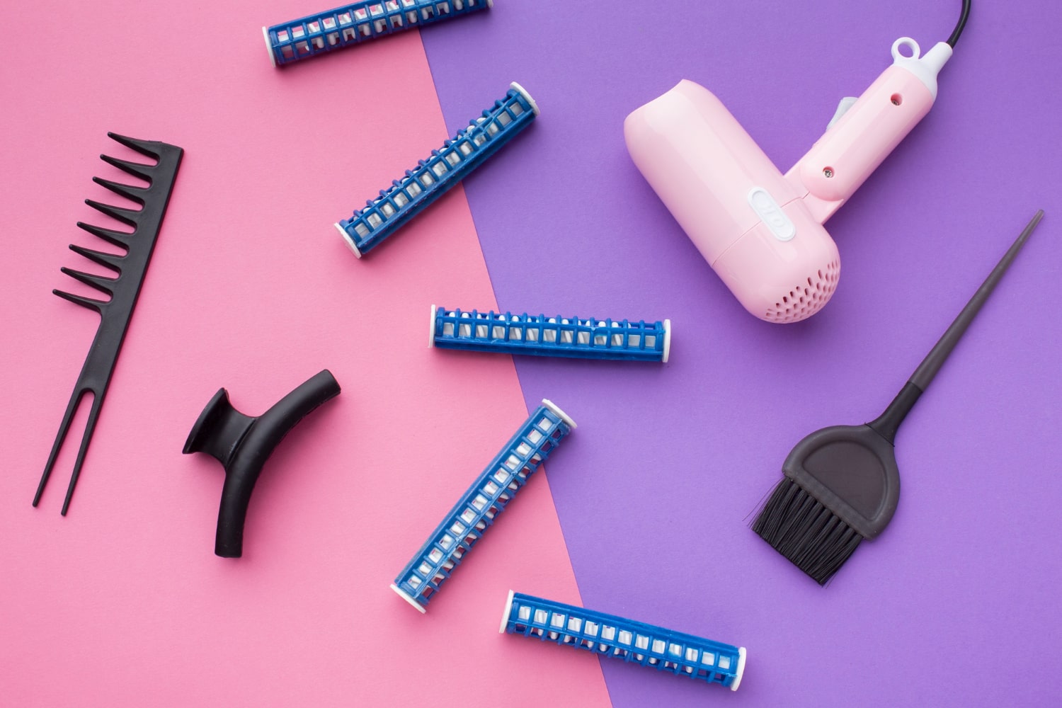Hair styling tools on a two-tone background
