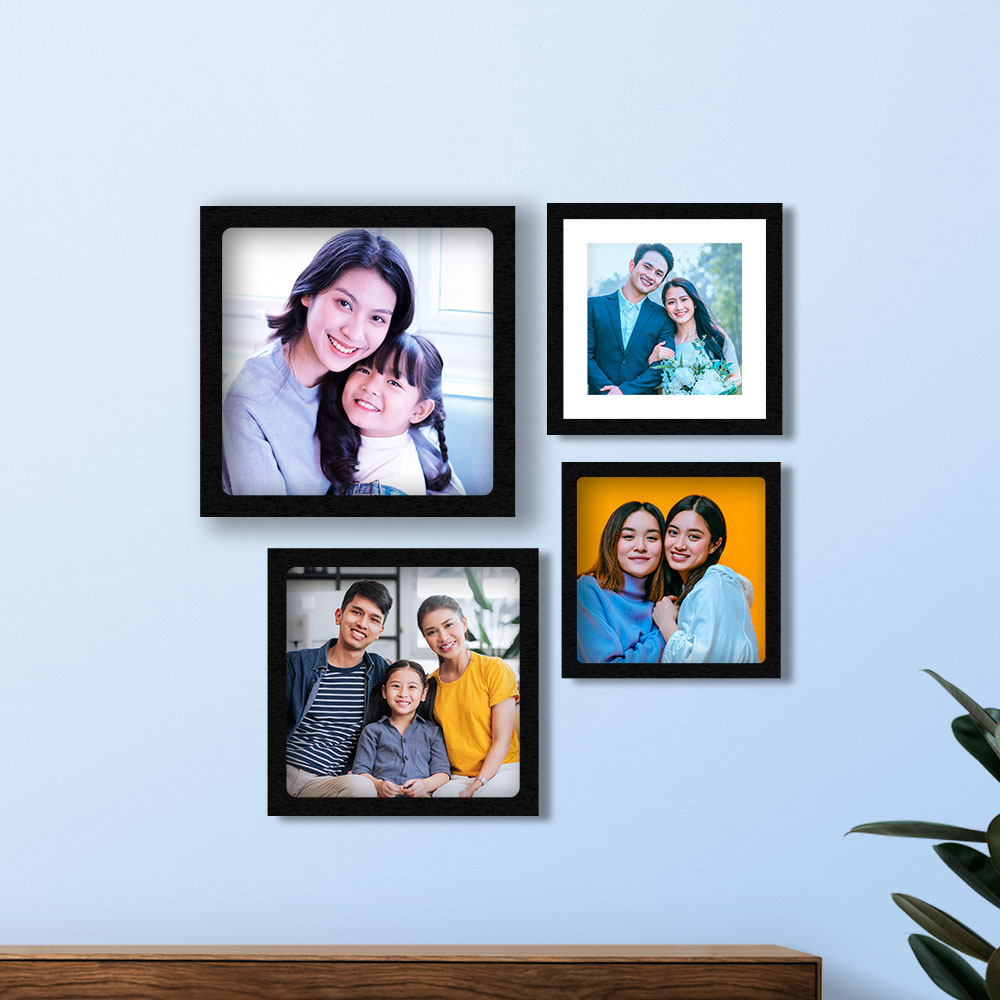 Four framed photos on a wall with a plant for christmas decoration