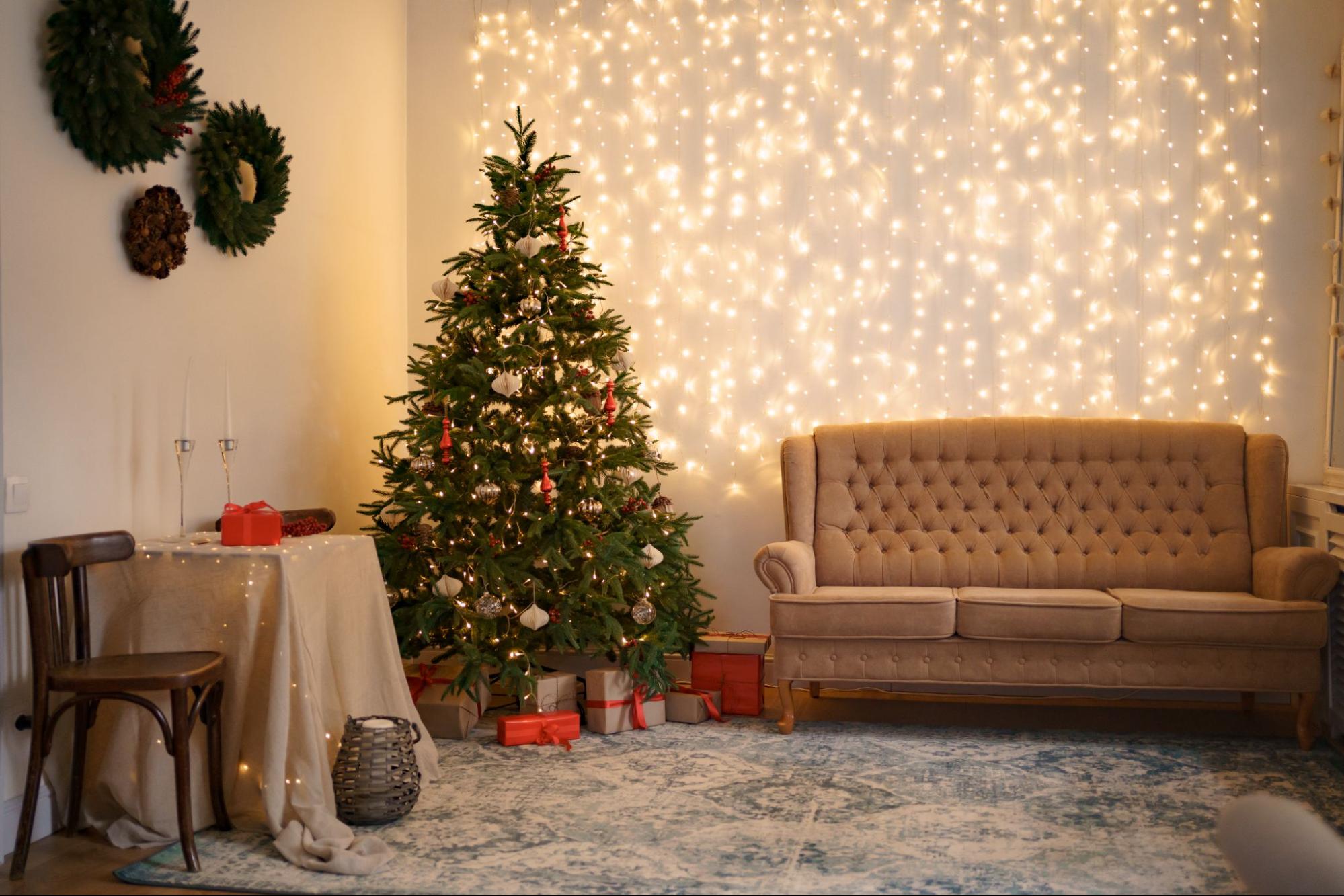 A cozy living room adorned with a beautifully decorated Christmas tree and a comfortable couch, exuding warmth and holiday cheer