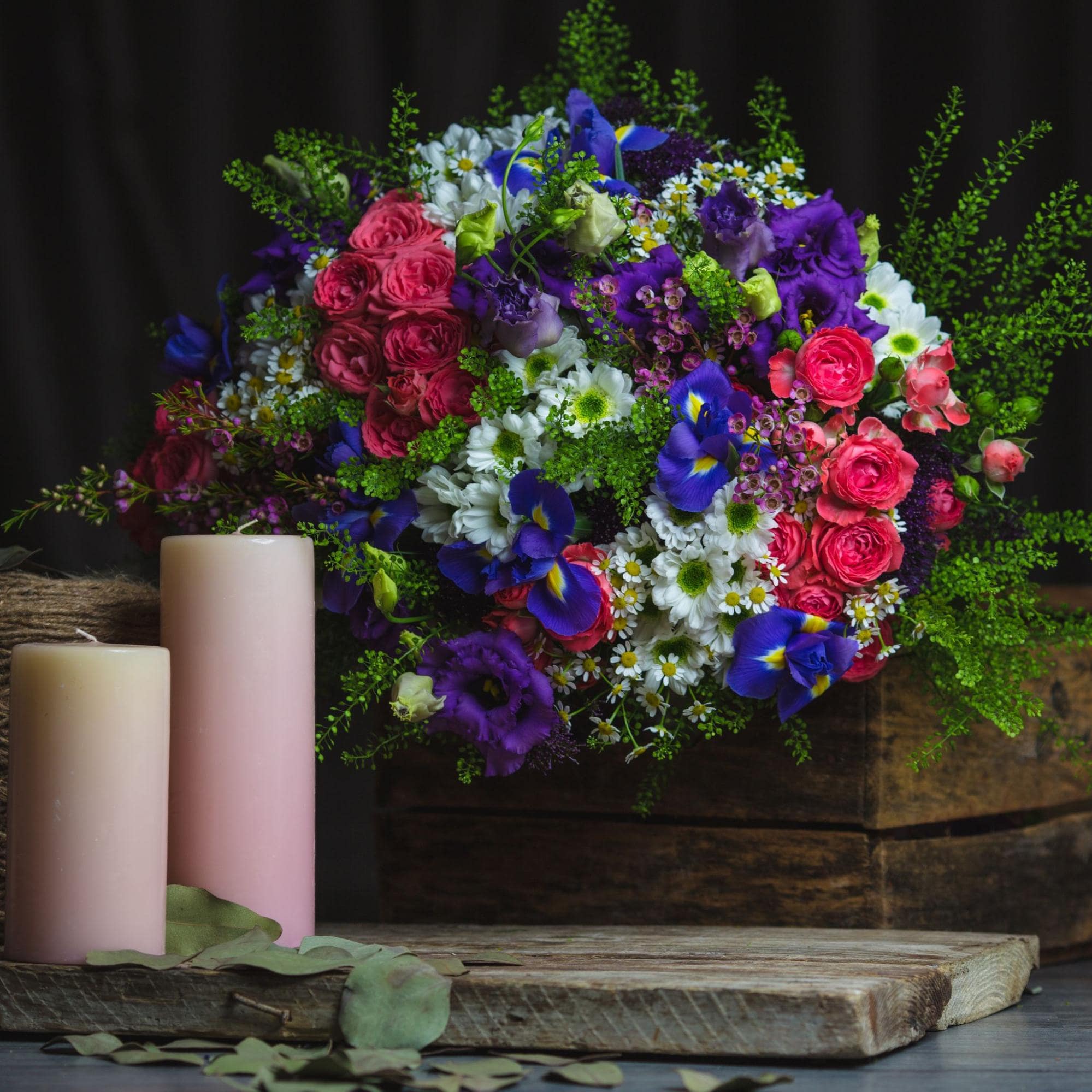 Immerse in floral beauty, candles on a wooden table—a perfect Chinese New Year gift, spreading joy.