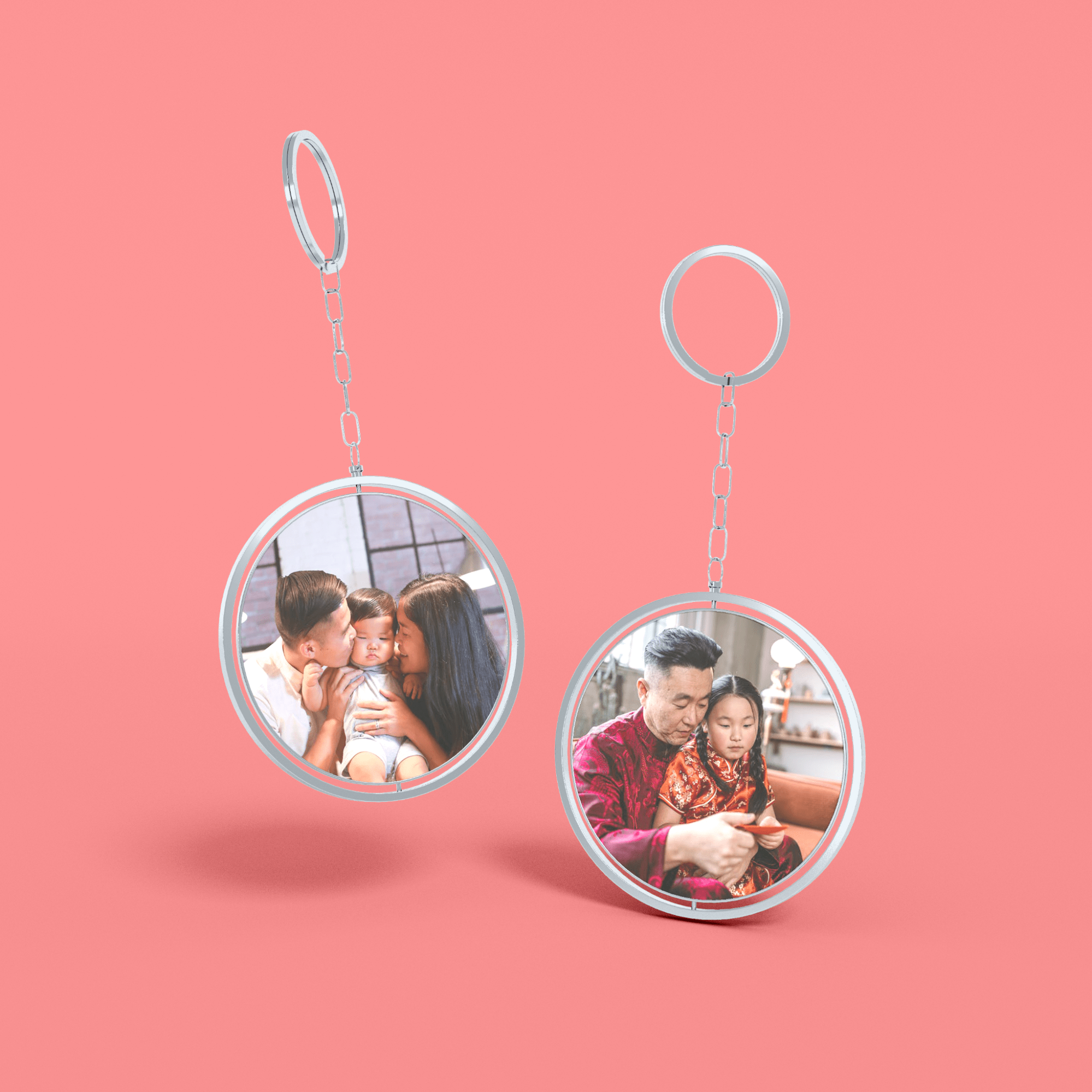 Two personalized keychain photos hanging from a chain against a vibrant pink background.