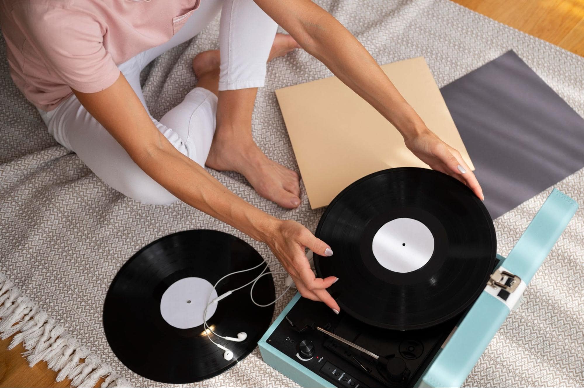 Woman using record player—vintage birthday gift idea for music-loving girlfriend.