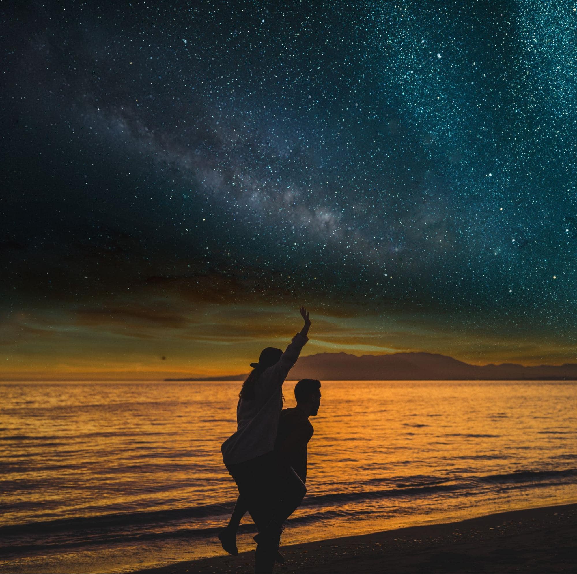  Stargazing couple on beach—unforgettable birthday gift experience for girlfriend