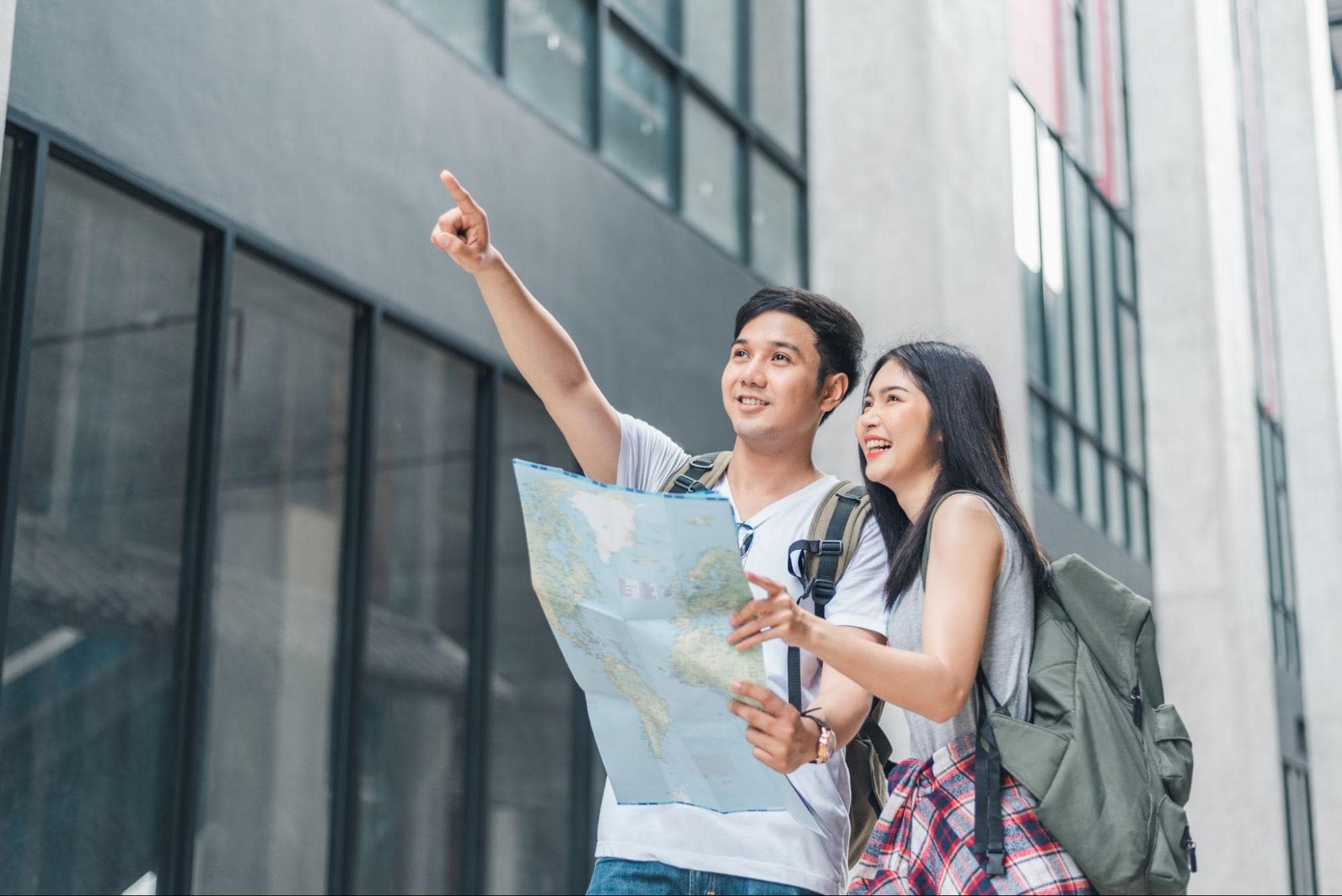 Traveling couple with map, ideal birthday gift experience for your girlfriend