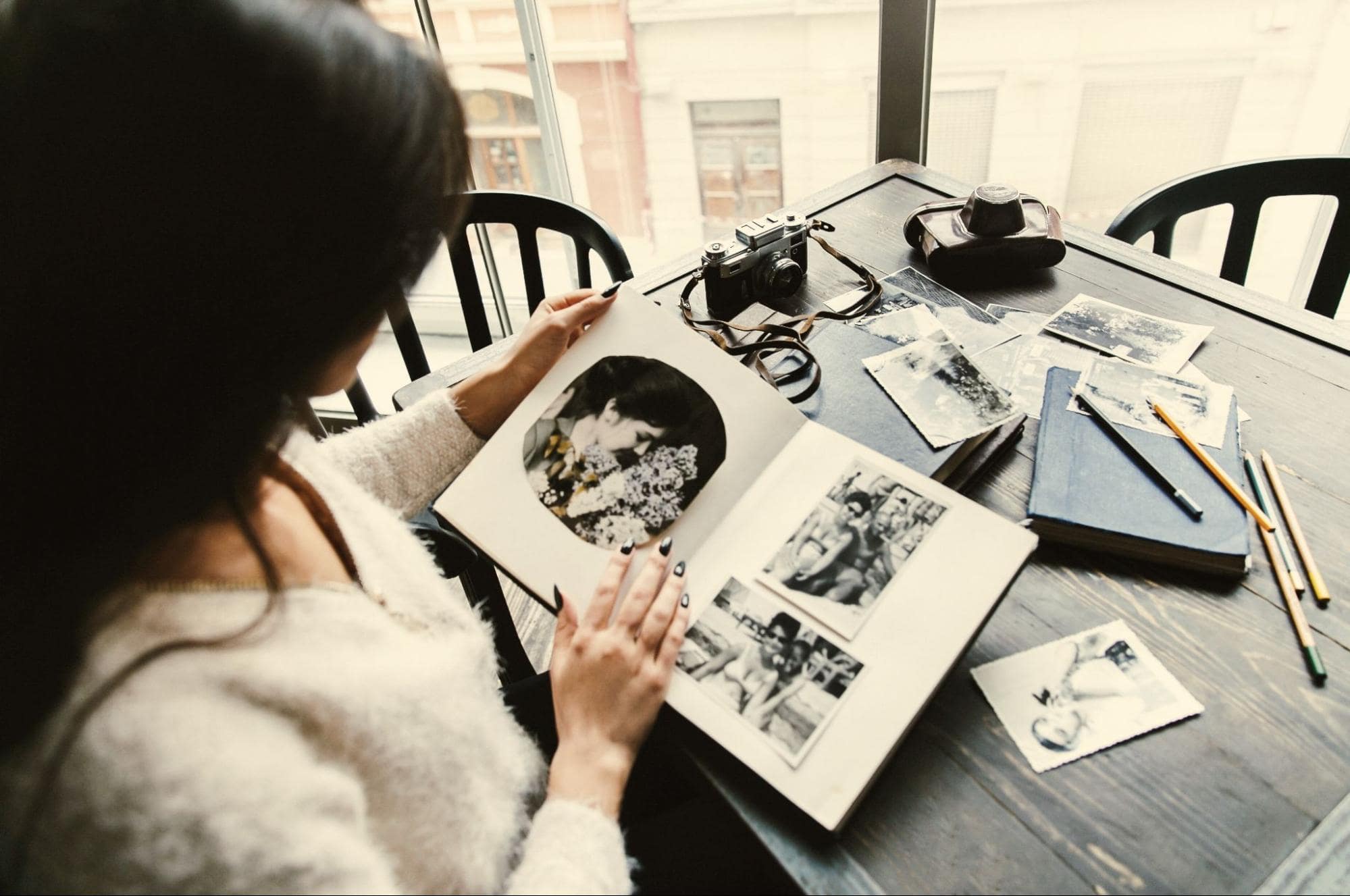 Woman with photo album, a sentimental birthday gift for a girlfriend